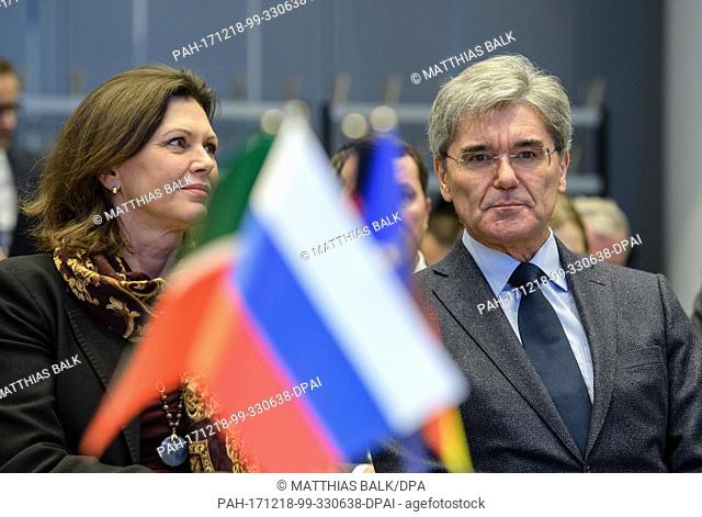 Joe Kaeser, Chairman of the Board of Siemens, sitting next to Bavarian Minister of Economy, Ilse Aigner, behind a Russian flag during the signing of an...