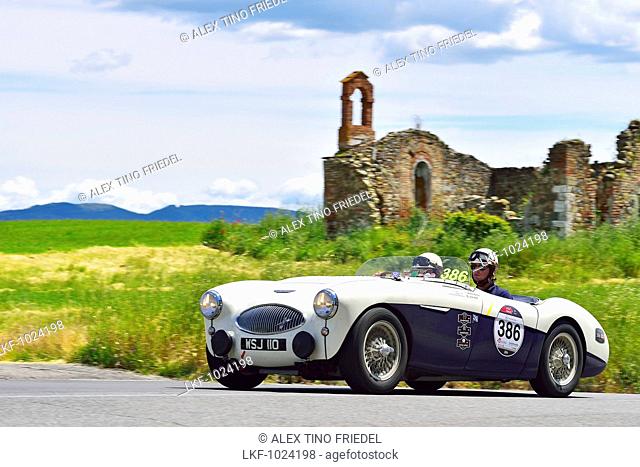 Austin Healey 100 S, 1955, Oldtimer on a road near ruins through the Tuscan valley, Mille Miglia, 1000 Miglia, 2014, San Quirico D'orcia, Siena, Tuscany, Italy