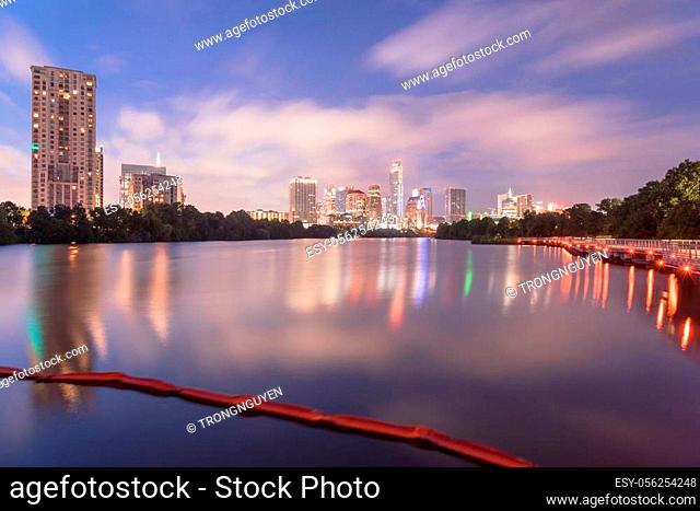 Beautiful downtown Austin, America from boardwalk along Colorado River. Long exposure reflection image of modern cityscape landmark building of Texas capital at...