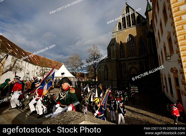 13 January 2023, Baden-Wuerttemberg, Salem: Groups in traditional costumes walk across the forecourt of Salem Minster on the day of the second funeral service...