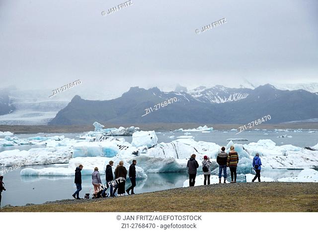 tourists at Jokulsarlon glacier lake in Iceland