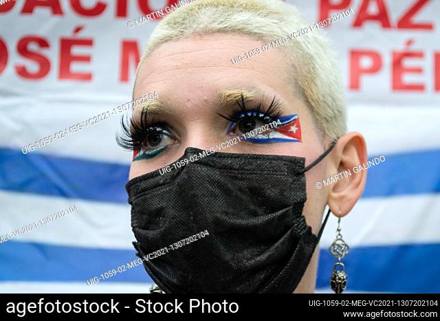 A demonstrator with make-up of Cuba's national flag as Cuban residents residing in Colombia that protest against the president Miguel Diaz-Cannel protest in...