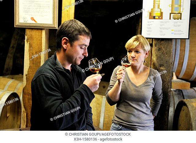 Nadege and Sylvain Fontan brother and sister co-owners tasting Armagnac in the cellar of Fontan vineyards, Maubet wine growing estate, Noulens