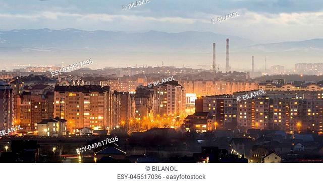 Panorama of night aerial view of Ivano-Frankivsk city, Ukraine. Scene of modern night city with bright lights of tall buildings