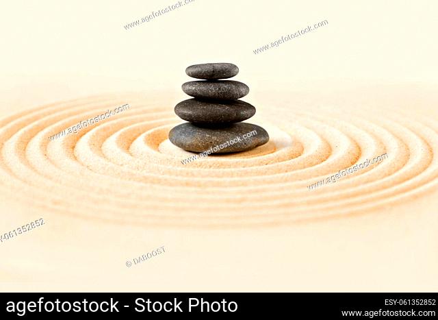 Black stones pile in the sand. Zen japanese garden background scene