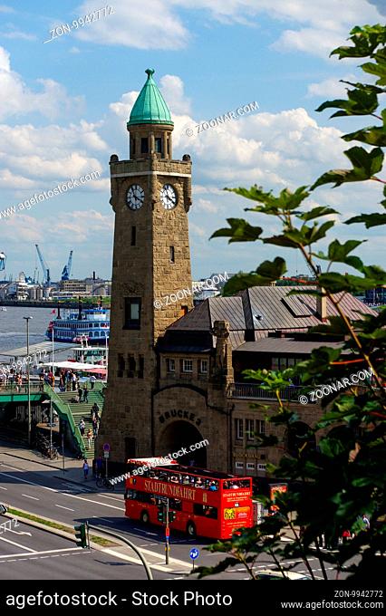HAMBURG, GERMANY - JULY 18, 2016: a Beautiful view of famous Landungsbruecken with commercial harbor and Elbe river with blue sky and clouds in summer, St