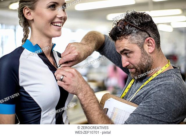 Tailor with model fitting sportswear
