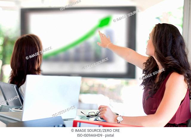 Businesswoman pointing to graph