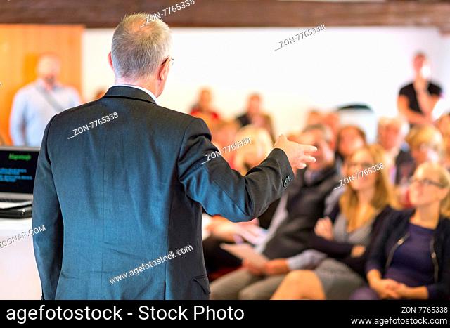 Business man leading a business workshop. Corporate executive delivering a presentation to his colleagues during meeting or in-house business training