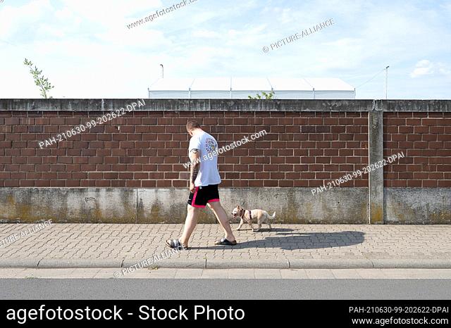 28 June 2021, Hessen, Hanau: A man trains with his dog Emma during puppy class at a dog school. to dpa: ""First loved, then deported?"")
