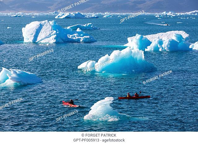 KAYAKING IN THE MIDDLE OF THE ICEBERGS THAT SEPARATED FROM THE GLACIER, FJORD OF NARSAQ BAY, GREENLAND