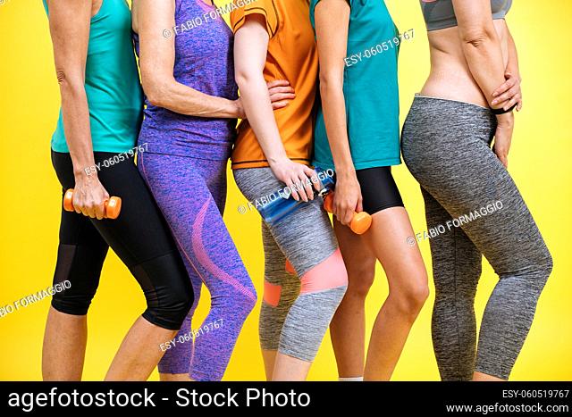 Group of women with different body, age, and ethnicity making sport. Female models wearing sport outfits having fun at the gym
