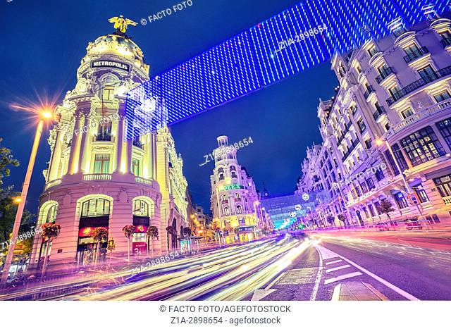 Grassy building and Gran Via street at Christmastime. Madrid. Spain