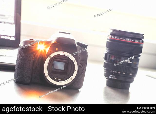 Professional reflex camera on a table, camera sensor. Lenses in the blurry background
