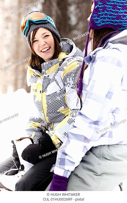 Teen girls in snowboard gear smiling