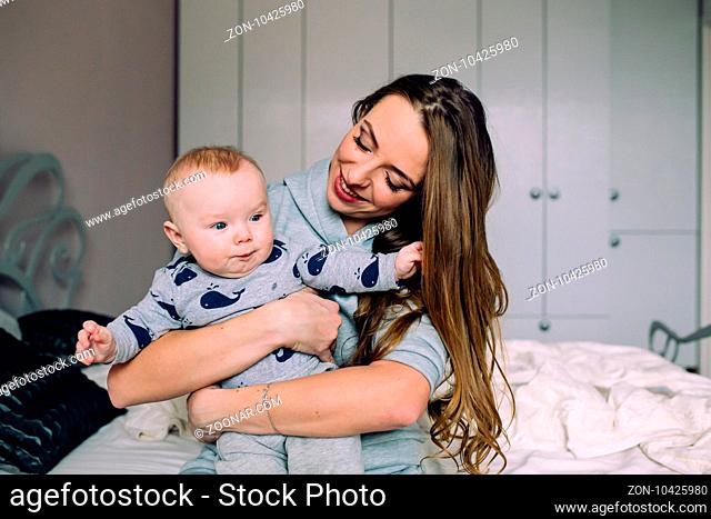 Mother and baby daughter together in the bedroom