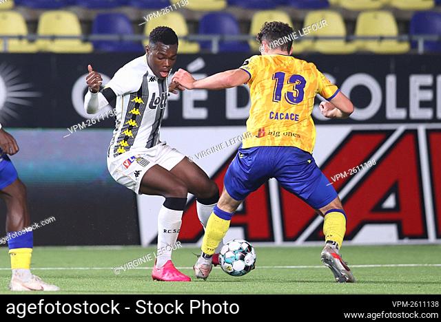 Charleroi's Ken Nkuba Tshiend and STVV's Liberato Cacace fight for the ball during a soccer match between Sint-Truiden VV and Sporting Charleroi