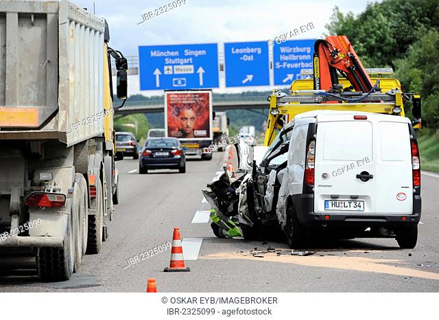 A heavily damaged van is recovered after an accident on the A8 road near Leonberg by a tow truck, Baden-Wuerttemberg, Germany, Europe