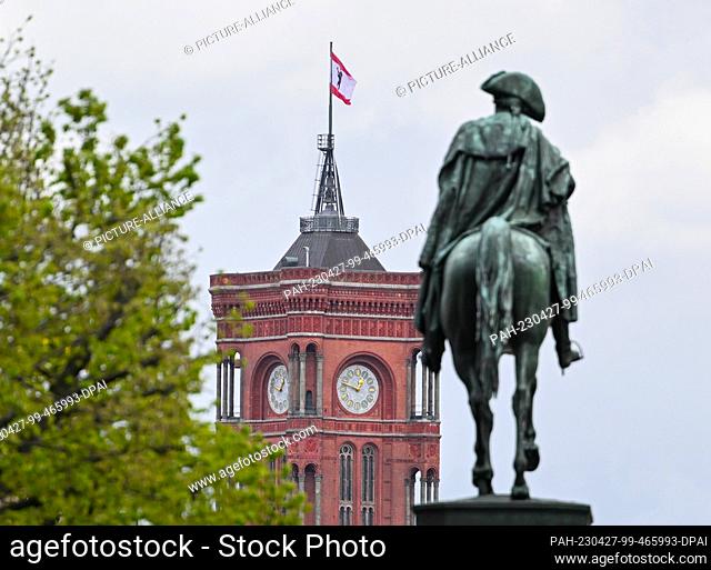 26 April 2023, Berlin: The tower of the Red City Hall can be seen behind the equestrian statue of Frederick the Great. Photo: Soeren Stache/dpa