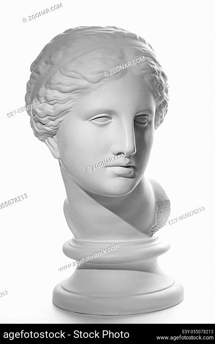 White gypsum copy of ancient statue of Venus de Milo head for artists on a white background. Plaster sculpture of woman face