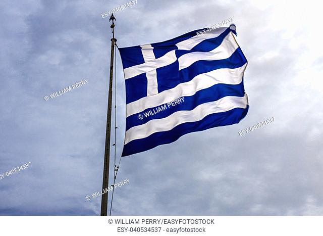 Blue White Greek Flag Summit Acropolis Athens Greece. Cross symbolizes Greek Orthordox Chritiianity, the religion of Greece, Acropolis is symbol of Athens