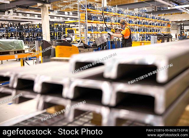 04 August 2021, Hamburg: An employee works on construction parts and intermediate products in a logistics terminal of Still, a manufacturer of forklift trucks
