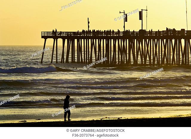 Sunset light over the pier and ocean waves at Pismo Beach, San Luis Obispo County coast, California