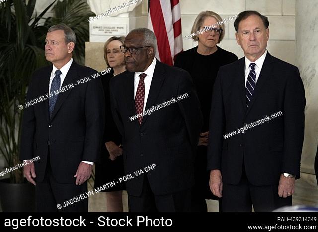 From left to right: Chief Justice of the United States John Roberts, Associate Justices of the Supreme Court Clarence Thomas and Samuel Alito attend a private...