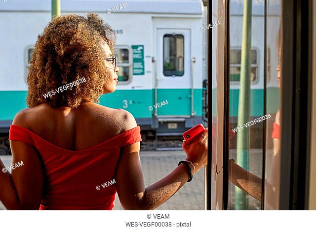 Woman looking out of train door