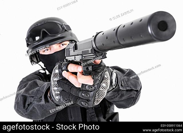 Spec ops police officer SWAT in black uniform with pistol studio