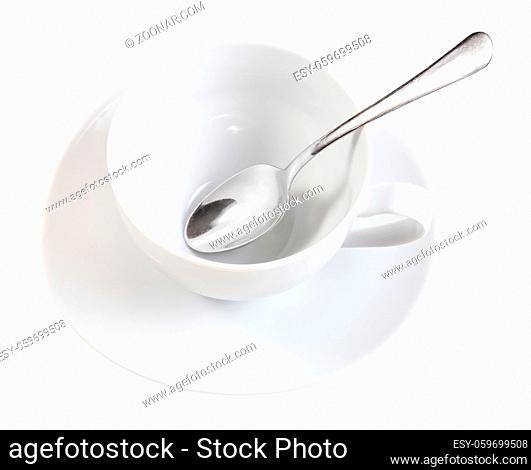 above view of white porcelain cup with spoon on saucer isolated on white background