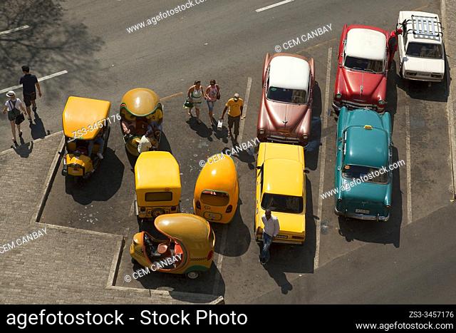 Old American cars and coco-taxis near Parque Jose Marti-Central Park in the center Havana, La Habana, Cuba, Central America