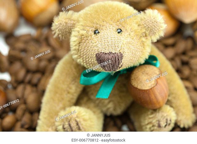teddy bear with a bow, coffee beans and nuts