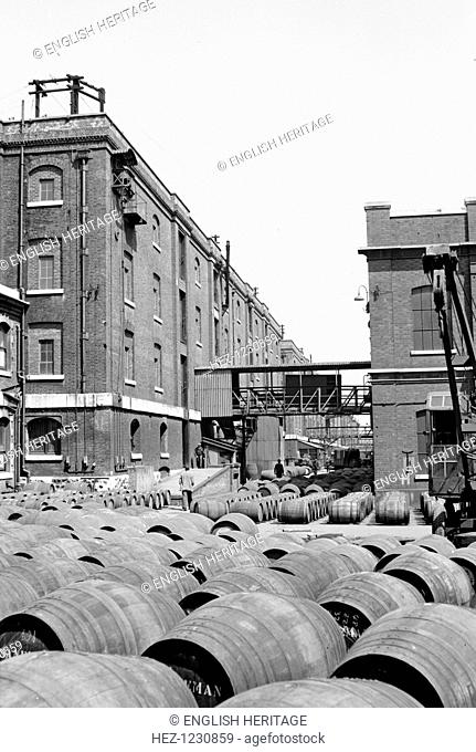 Warehouses at the Wine Gauging Ground, North Quay, London Docks, c1945-c1965. Wine barrels marked `Sandeman' in front of warehouses at the Wine Gauging Ground