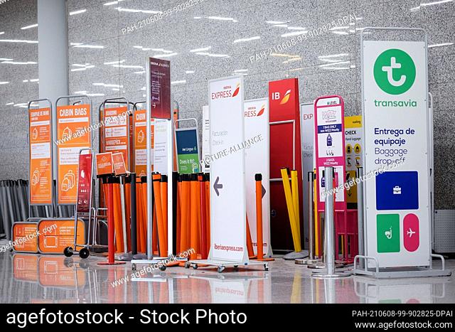 05 June 2021, Spain, Palma: Signs, information on hand luggage and barriers from low-cost airlines have been put together at Palma Airport
