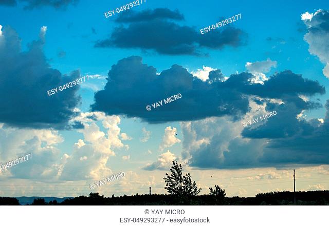 White and dark blue clouds on sky during sunset