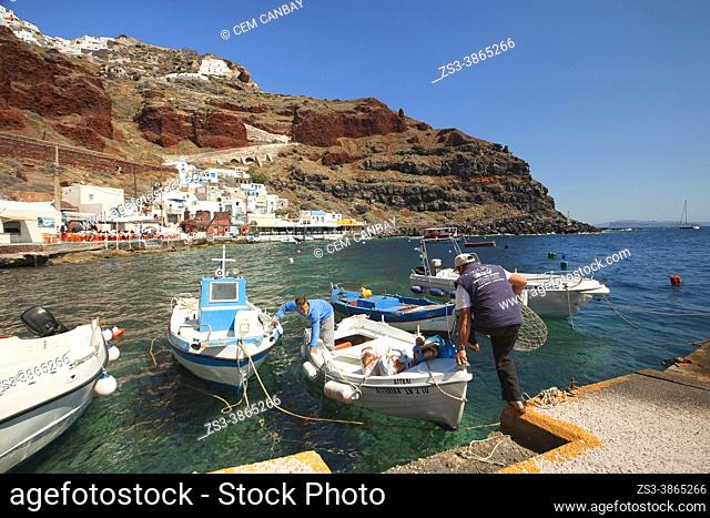 View to the fishermen, traditional fishing boats and traditional Cycladic buildings in Ammouidi bay below Oia village, Santorini Island, Cyclades Islands