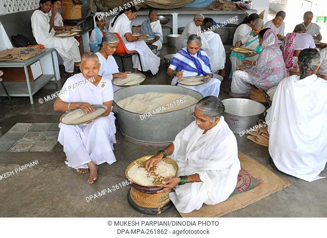 woman sorting rice, brahma kumari ashram, mount abu, rajasthan, india, asia