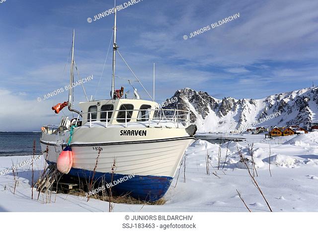 Fishing boat on a snowy shore. Bleik, Andoya, Norway
