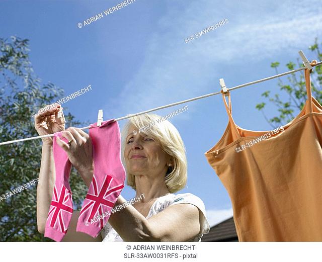Woman hanging socks on clothesline