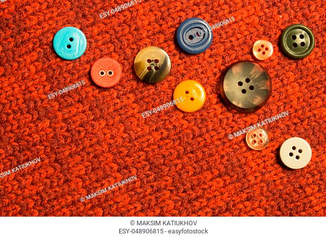 Various sewing buttons on textile background. copy space