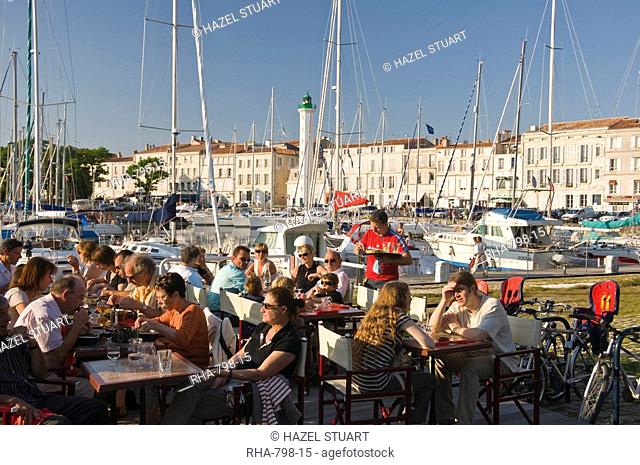 Open-air restaurant seating next to the ancient harbour at La Rochelle, Charente-Maritime, France, Europe