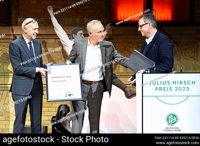 13 November 2023, Berlin: DFB President Bernd Neuendorf (l) presents the honorary award to Christian Streich (M), soccer coach of SC Freiburg