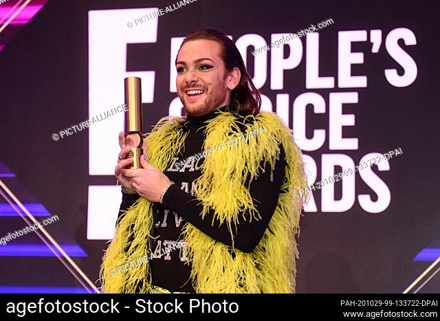 29 October 2020, Bavaria, Unterföhring Bei München: The entertainer and presenter Riccardo Simonetti holds his award in his hand during a photo session on the...