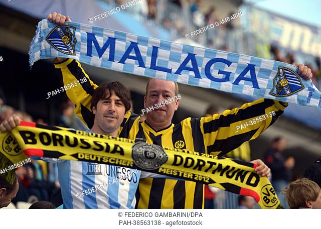 Supporters of Dortmund (R) and Malaga cheer prior to the UEFA Champions League quarter final first leg soccer match between FC Malaga and Borussia Dortmund at...