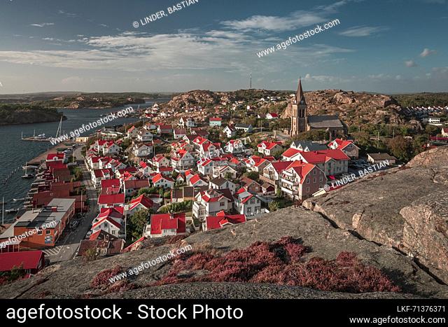Coast and village Fjällbacka from Vetteberget mountain with crevice from above during day with sun and blue sky on the west coast in Sweden