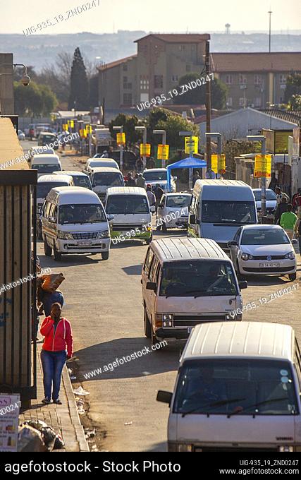 Soweto township street filled with minibus taxis, South Africa