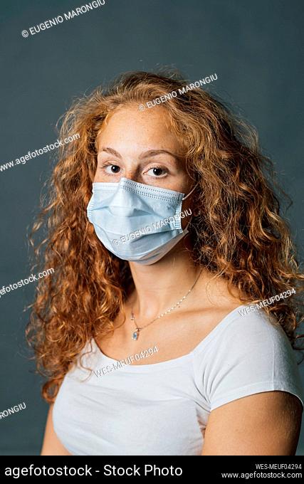 Young woman wearing protective face mask during pandemic