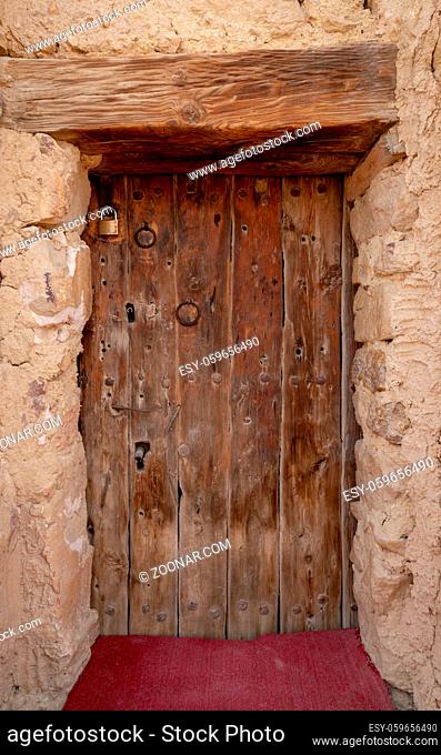 Wooden door leading to the fort of Monastery of Saint Paul the Anchorite located in the Eastern Desert, near the Red Sea mountains, Egypt