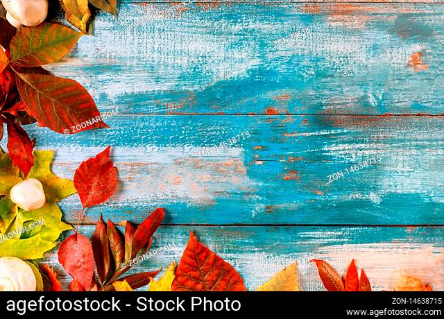 Old wooden table border from fallen maple leaves in the thanksgiving autumn background